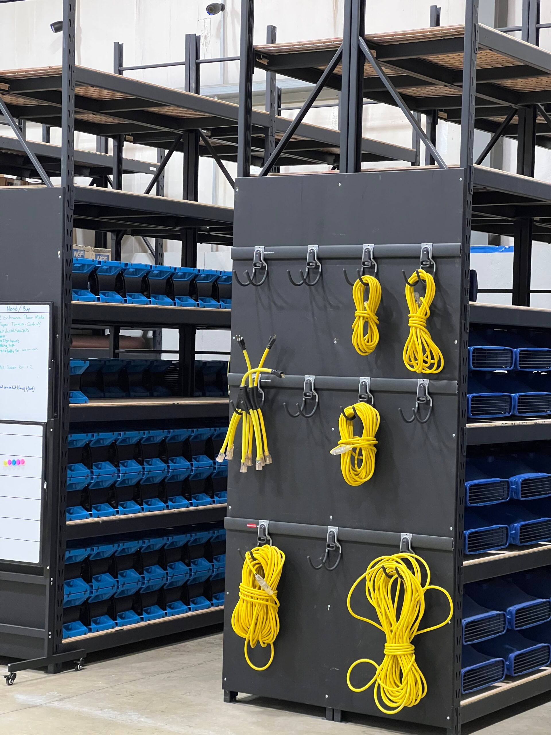 Organized restoration power cords hanging from warehouse equipment racks