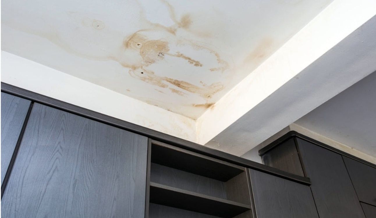 Brown ceiling stain caused by a leaking roof